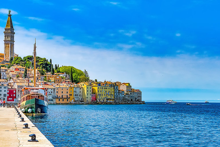 Küstenstadt Rovinj in Kroatien mit bunten Häusern direkt am tiefblauen Meer.