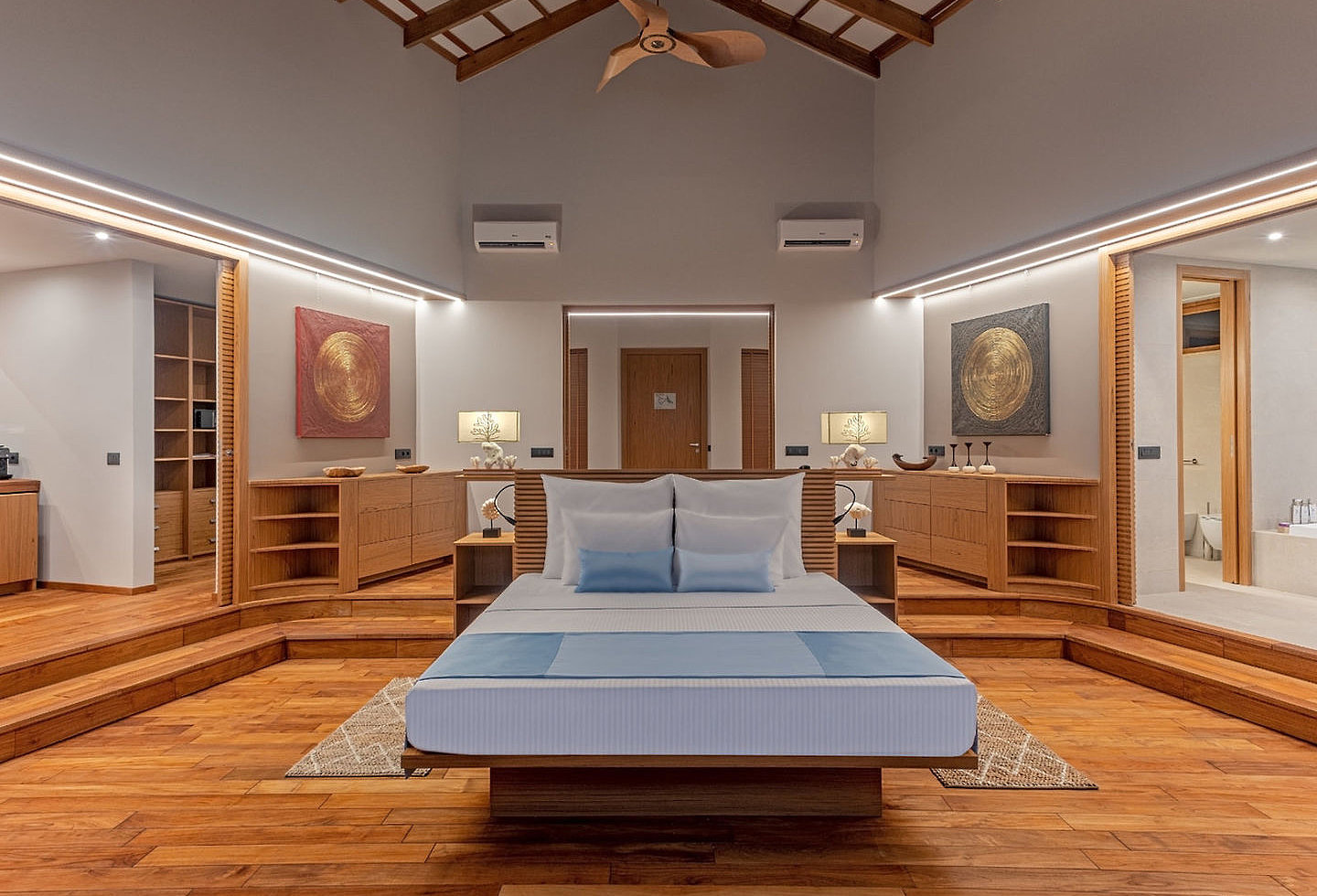 Modernes Hotelzimmer mit Doppelbett mit blauen Akzenten, in breitem Raum.